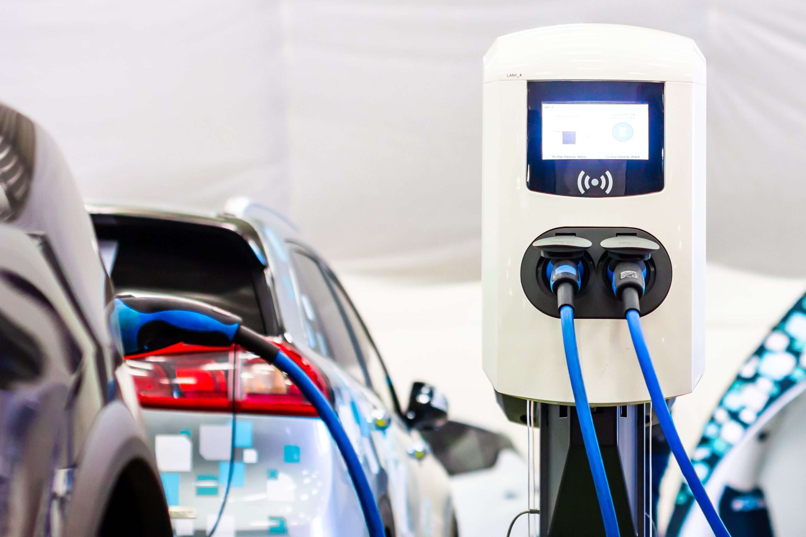 A modern electrical fast charger for the electrical or hybrid PHEV automobiles. An Energy power of future. Ecology friendly charger concept. Home electric car battery charger.