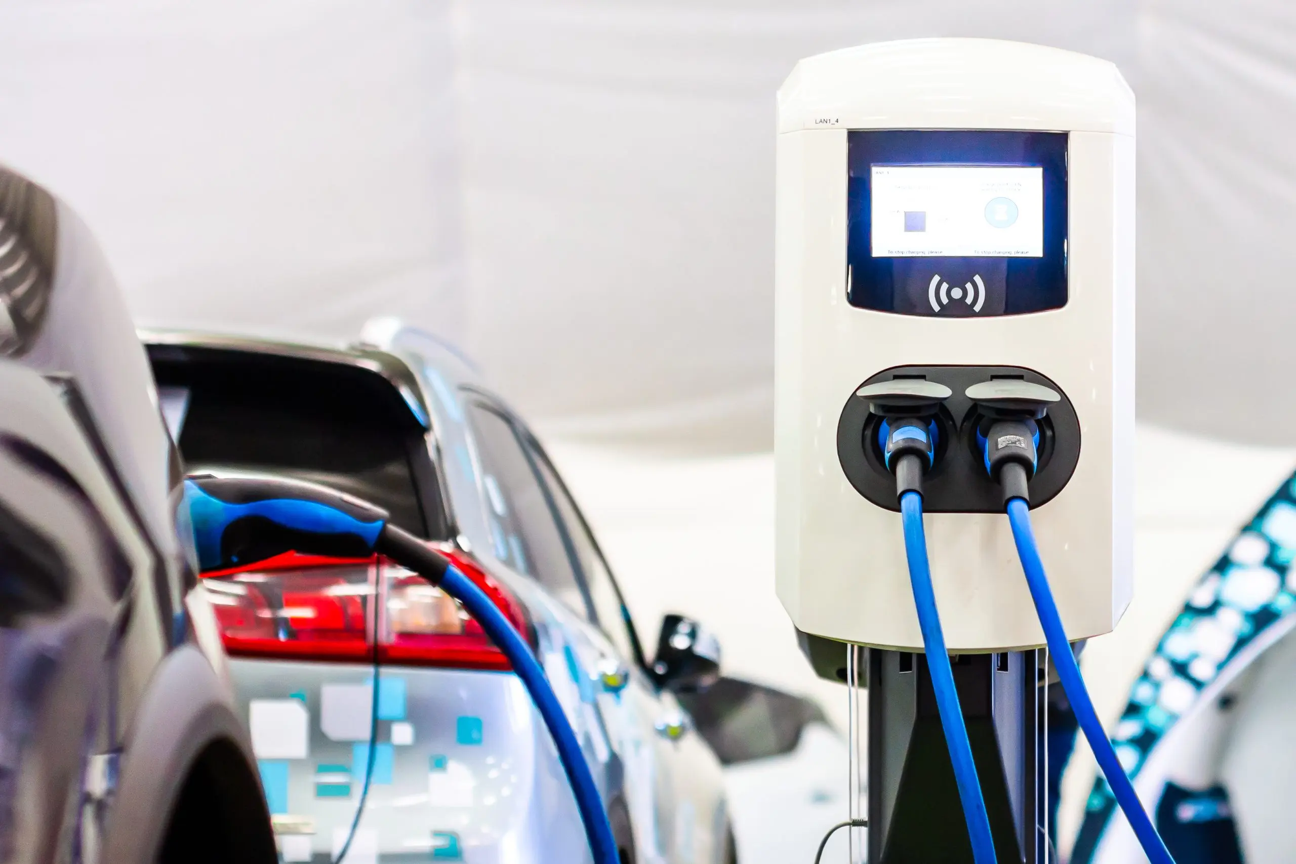 A modern electrical fast charger for the electrical or hybrid PHEV automobiles. An Energy power of future. Ecology friendly charger concept. Home electric car battery charger.
